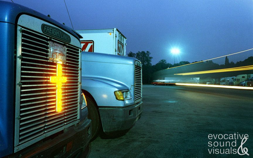 An illuminated cross helps light the way on Cisco, Texas-based trucker Rolen Riggs' cab as he waits to exit the Columbia 20 Travel Center on Interstate 20. Photo by Richard Alan Hannon