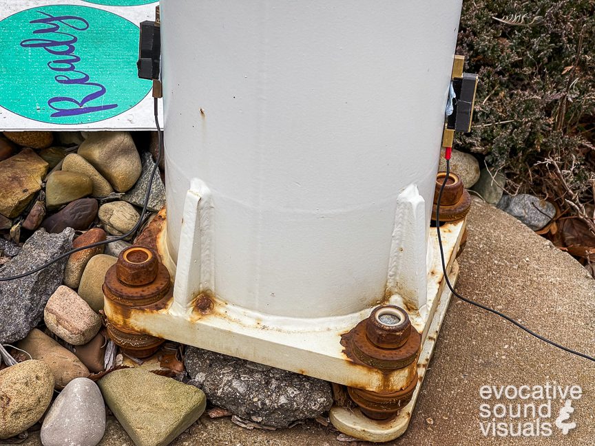 Recording the sound of a Windspire Energy Model 800080 vertical axis wind turbine, built in 2010, with a pair of contact microphones in Northfield, Ohio on January 5, 2022. The manufacturer states on the bottom of the unit that there are “no user serviceable parts inside,” which in this case is clearly too bad, as this unit is incredibly squeaky, like fingers raking across a chalkboard, and a bit wobbly as well. Photo by Richard Alan Hannon