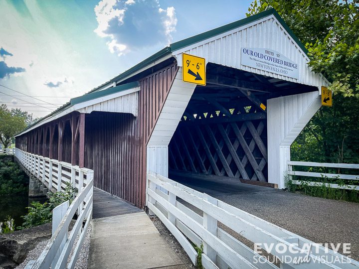 The historic 123-foot long, 24-foot wide one-way covered bridge in Newton Falls, Ohio on Wednesday, August 14, 2024. The historic wooden bridge was built over the east branch of the  Mahoning River in 1831 and is the second oldest existing covered bridge in Ohio and the oldest covered bridge in use in Ohio on its original posts. A crosswalk was added in 1921 to allow children to attend school in town. Photo by Richard Alan Hannon