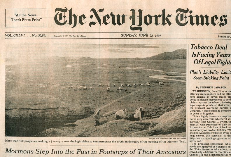 The New York Times newspaper front page from June 22, 1997 showing re-enactors climbing Independence Rock in central Wyoming at dawn during the Sesquicentennial Celebration of the Mormon Trail in June 1997. Photo by Richard Alan Hannon